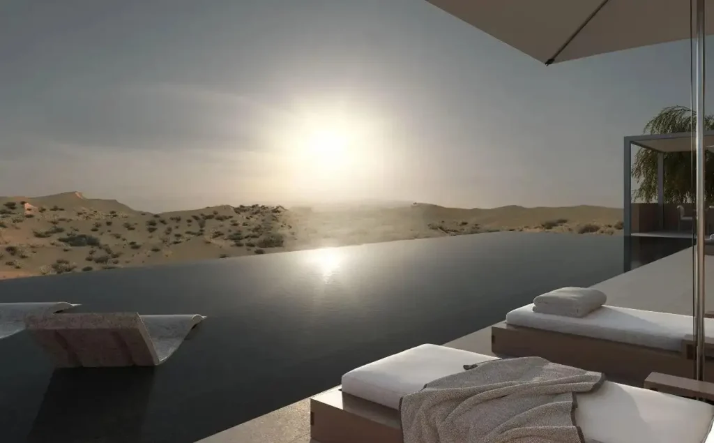 Infinity pool overlooking the Al Wadi desert at sunset