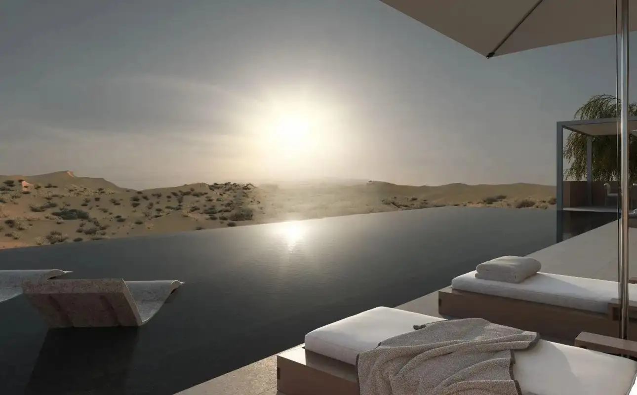 Infinity pool overlooking the Al Wadi desert at sunset